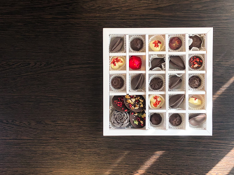 A box of handmade chocolates of different colors