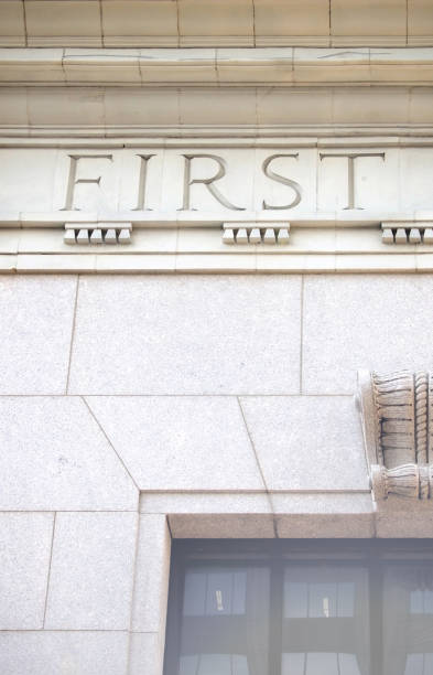 first word written in stone in carved classical times letters above a window