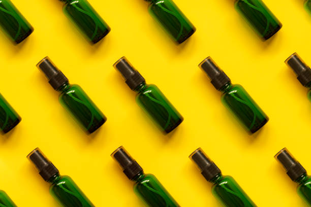 Flat lay spray bottle on yellow background
