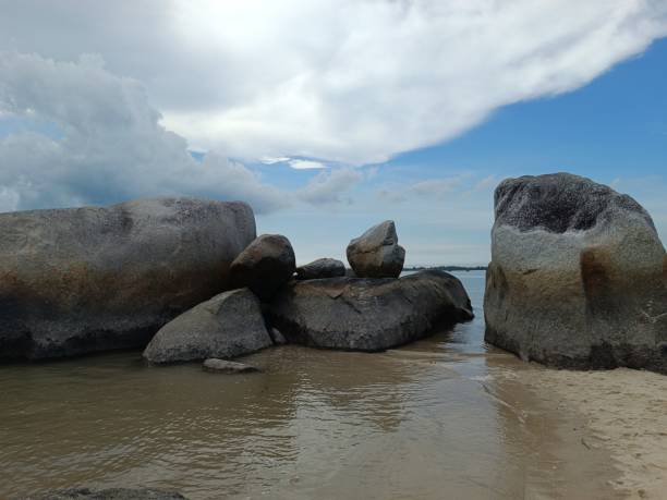 istock Putat Beach - Bangka Island , beautiful beachfront scenery with several large rocks above the water level, and tropical trees in the end area 1485007139