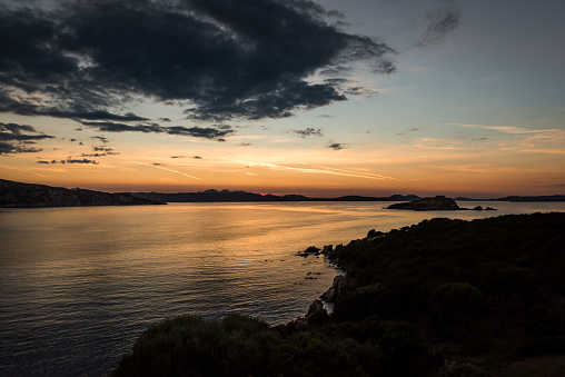 From high above, the seascape right before the sunset is an awe-inspiring sight to behold. The sun's warm rays dance across the calm sea, painting it with brilliant hues of orange and gold. \n\nAs the sun slowly descends towards the horizon, the sky transforms into a breathtaking work of art.\n\nThe stillness of the sea below is casting a golden glow.\n\nFrom this high vantage point, one can feel a sense of tranquility and peace that is difficult to find elsewhere. The world below seems to slow down, and all worries and concerns fade away. It is a moment to be cherished, a moment of pure beauty and wonder.