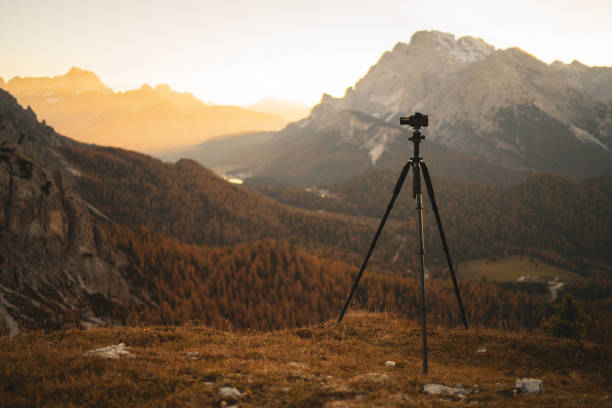 istock camera on tripod waiting for sunrise in the mountains 1485011944