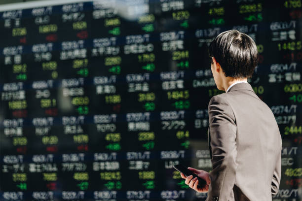istock See the stock price board displayed with a smartphone in hand. 1485013499
