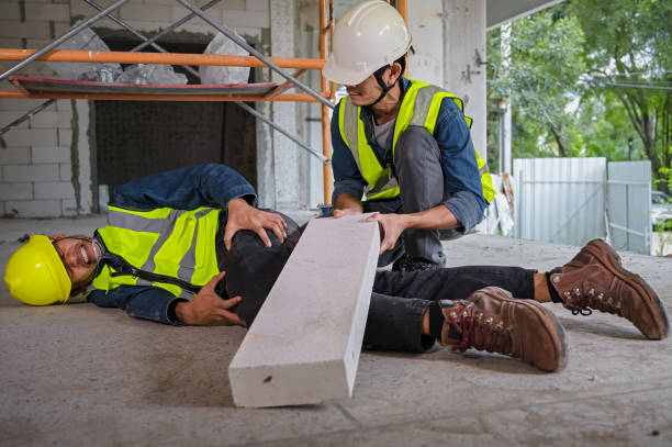 istock Young Asian builder falls from a height at a construction site. An engineer supervising the construction came to the aid of a construction worker who fell from a height with knee and leg injuries. 1485015073