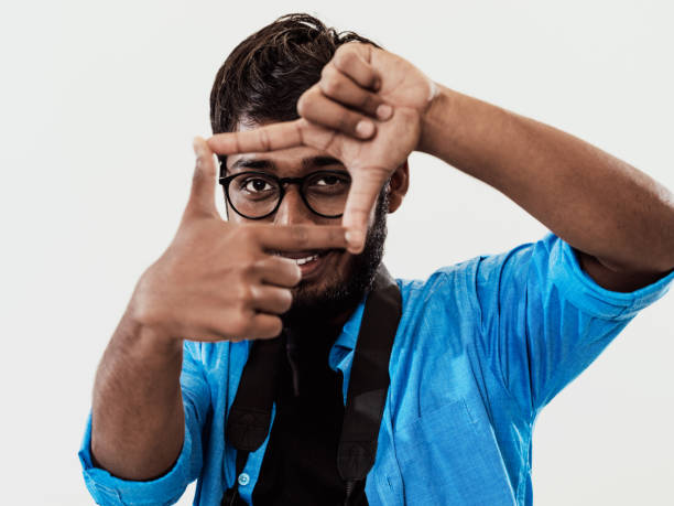 istock Young handsome man focusing with fingers, framing with hands isolated on grey background. Close up portrait 1485017677