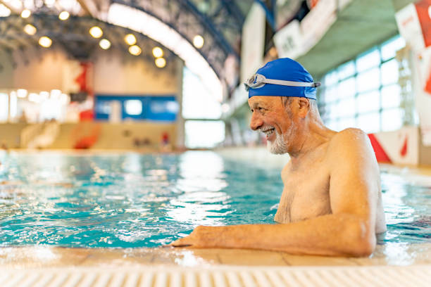 istock Handsome senior man relaxing in swiming pool during the day. 1485021071