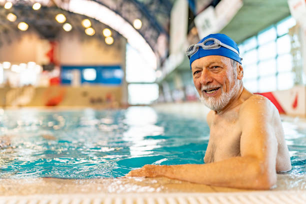 istock Senior man in an indoor swimming pool. 1485021078