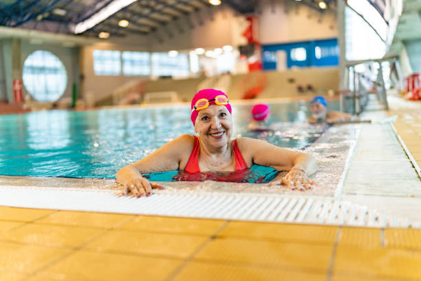 istock Smiling retired senior woman leaning at poolside 1485021121