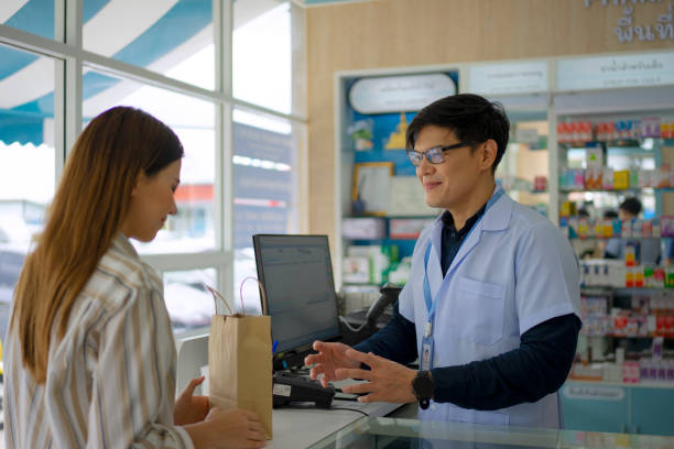 istock pharmacist and customer at pharmacy store. 1485024507