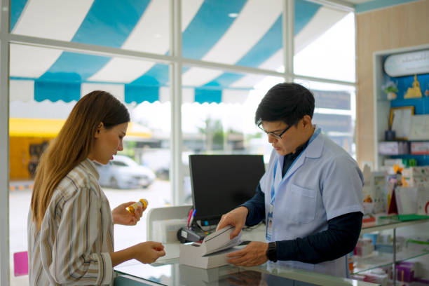 istock pharmacist and customer at pharmacy store. 1485024632