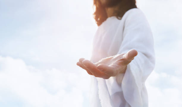 Jesus with Open Arms and Hands Resurrected Jesus Christ Heaven and cross love and faith and salvation concept of Jesus Christ reaching out with open arms in the sky and the resurrected Jesus Christ the passion of jesus stock pictures, royalty-free photos & images