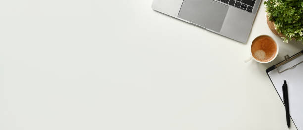 istock Copy space White office desk table with blank space notebook, laptop and other office supplies. Top view with copy space 1485025130