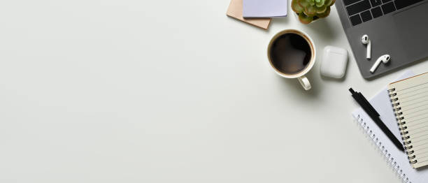 istock Copy space White office desk table with blank space notebook, laptop and other office supplies. Top view with copy space 1485025132