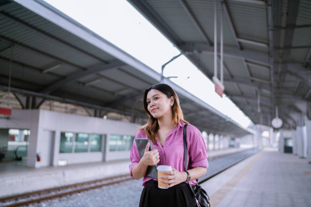 istock Asian Woman Waiting for Rapid Transit While on the Way to Meet Client. 1485025342