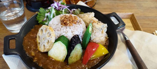 Japanese curry rice with fried chicken, karaage, and vegetables. stock photo