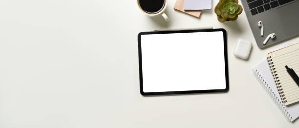 istock Digital tablet on white office desk table notebook, laptop and other office supplies. Top view with copy space 1485025639