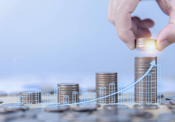 istock Man saving money putting coins on stack of coins 1485026226