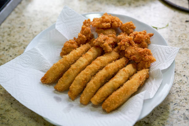 A fried food platter of crispy cod sticks and chicken nuggets
