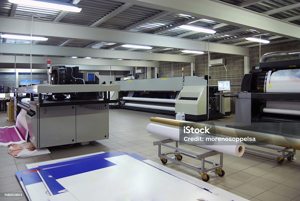 Digital printing - wide format printer Digital printing system for printing a wide range of superwide-format applications. These printers are generally roll-to-roll and have a print bed that is 2m to 5m wide. Mostly used for printing billboards and generally have the capability of printing between 60 to 160 square metres per hour. Printing Press Stock Photo
