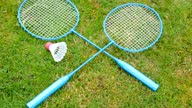 istock Badminton game rackets and shuttlecock on grass 1485028144