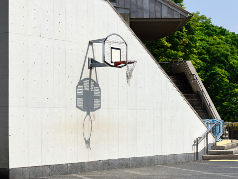 Basketball hoop on a white concrete wall with copy space.