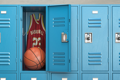 Basketball locker room with spotlight on the basketball ball and jersey in open locker. 3d illustration