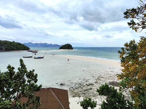 People walking at Thale Waek (divided sea) a sandbar connecting Koh Tup and Koh Mor island with Chicken island, off Ao Nang coast, Krabi province, Thailand