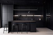 Sleek and modern, dark black kitchen exudes industrial edge and sophisticated style