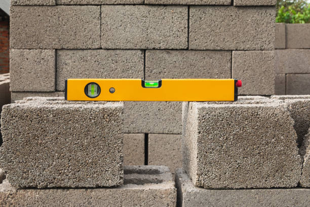 istock The bubble construction level lies on a cinder block construction stone. It is used by carpenters, masons, installers for various mounting and fastening works 1485035827