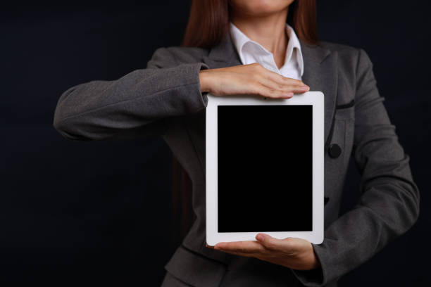 istock Attractive professional female hands standing and showing blank screen on tablet  for advertising on black background isolated 1485037372