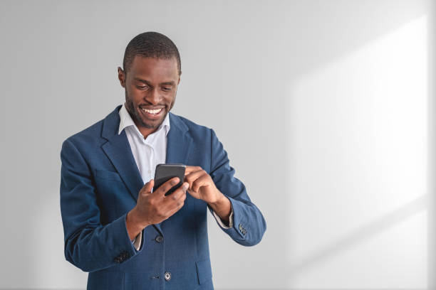 istock African businessman with smartphone, copy space empty background 1485038941