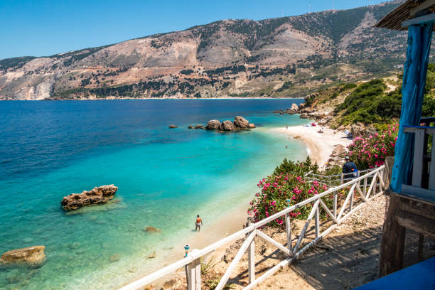 Myrtos Beach Kefalonia The most famous beach on Kefalonia (Cephalonia), Myrtos. Crystal clear water, some people on the beach kefalonia stock pictures, royalty-free photos & images