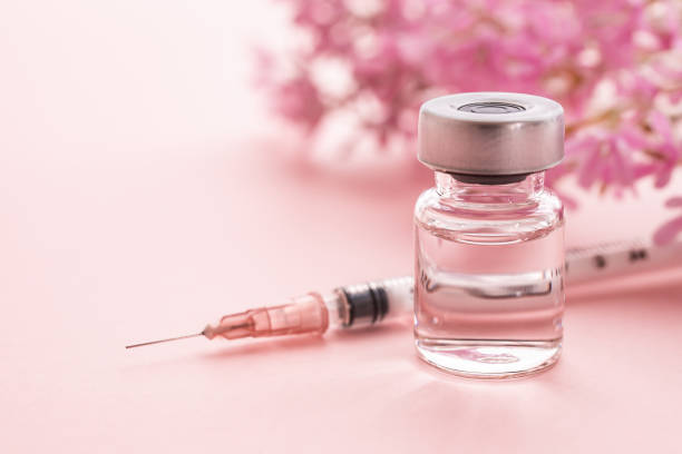 Beauty injections for cosmetic surgery and anti-aging. pink background. Syringe, cosmetic injection, cosmetic surgery, dermatology, obstetrics and gynecology, pink background hyaluronic acid injections stock pictures, royalty-free photos & images