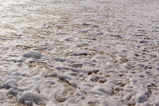 Sea foam and sand