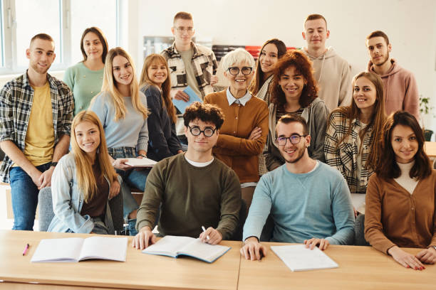 istock Happy mature professor with her students in the classroom. 1485045243