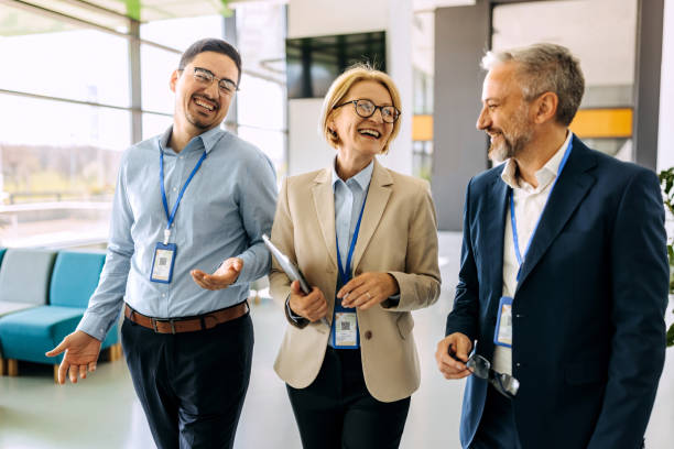 istock Business professionals talking while walking in office corridor 1485046053