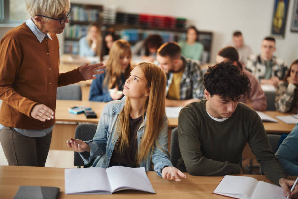istock Female student talking to senior teacher on a class. 1485047401