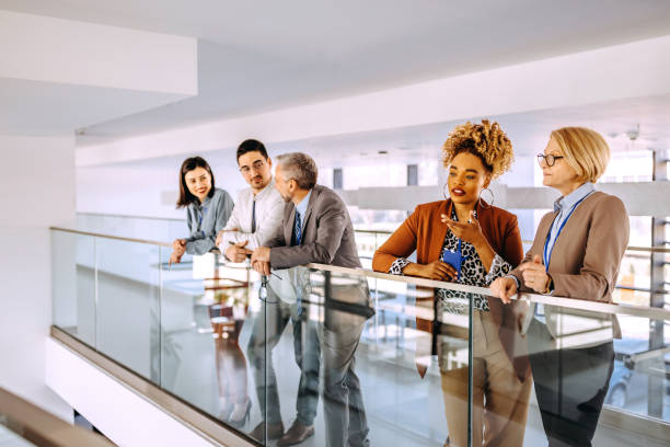 istock Colleagues having casual conversation in office corridor 1485047434