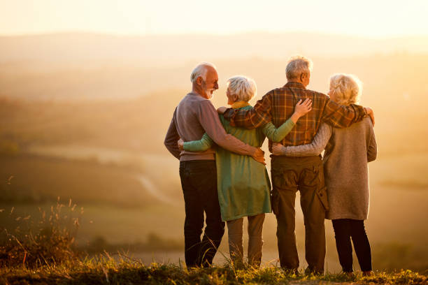 istock Back view of embraced seniors talking on a hill at sunset. 1485047875