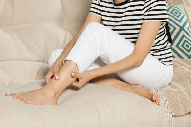 istock Woman rubbing sore leg on sofa, closeup 1485047881