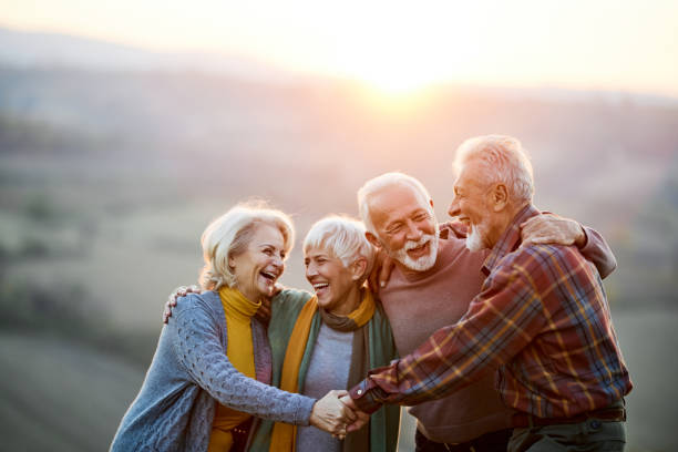 istock Happy embraced friends talking in nature at sunset. 1485047925
