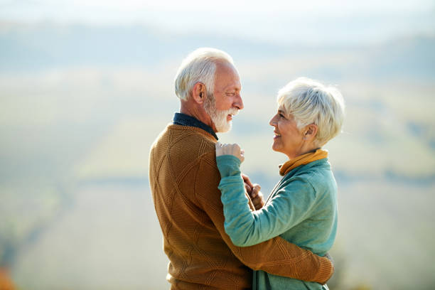 istock Embraced senior couple talking in autumn day. 1485048042