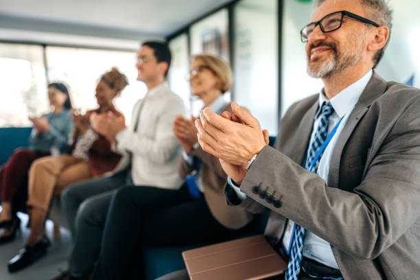 istock Businesspeople applauding during a seminar in conference hall. 1485049884