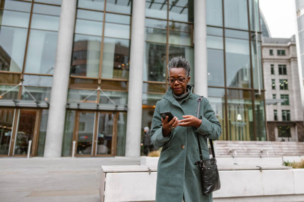 istock Senior Adult Black Female Walking Outdoors While Using A Smartphone 1485049983