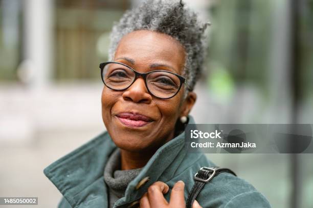 Portrait Of A Senior Adult Black Female On A City Street Looking At The Camera Stock Photo - Download Image Now