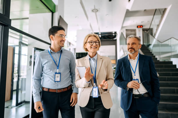 istock Colleagues talking and walking at office hallway 1485050830