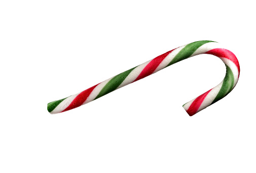 Close-up of a front curved colourful red and white green candy sugar cane stick bar made of icing on white background as a concept for candy Christmas and unhealthy eating