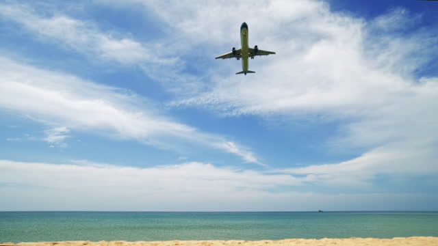 Passenger Plane in the Blue Sky. Airplane landing Over the Sea