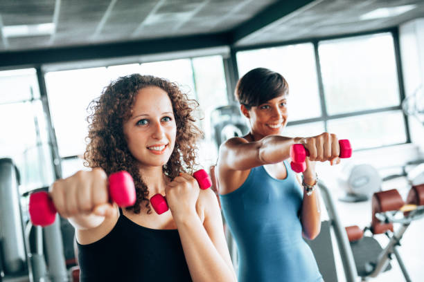 istock friends in the gym with dumbells 1485054596