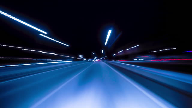 Bright Motion Timelapse of a Speedy Night Drive in a Big City, Windshield View. Hyperlapse Road Trip